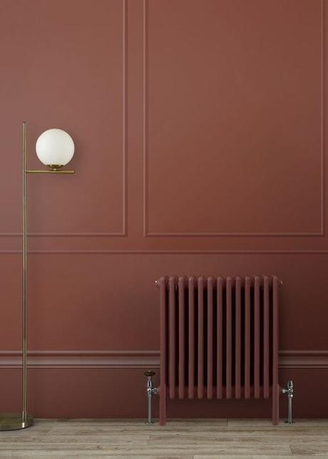 booth red radiator on a red wall to match the colour of the year 2025