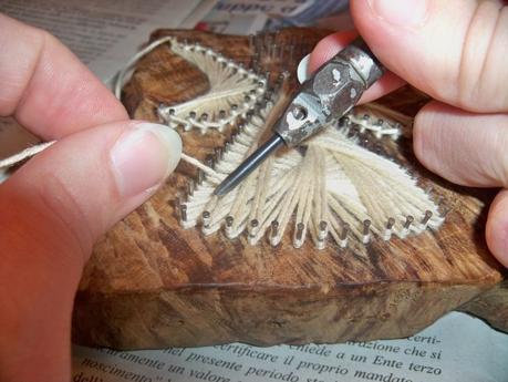 Using a hole punch is a great help weaving a string art project, and also fixing the thread to finish it