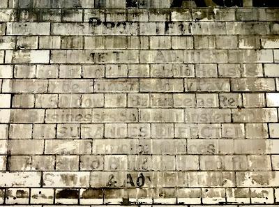 Estate Agent ghostsign at Fulham Broadway Station.