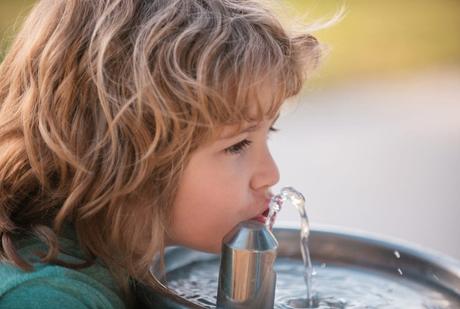 kid drinking from water fountain