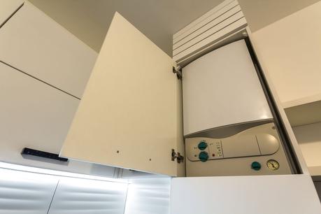 Boiler in white open cupboard