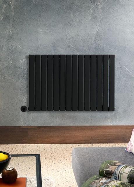 milano alpha black electric heater on a gray wall