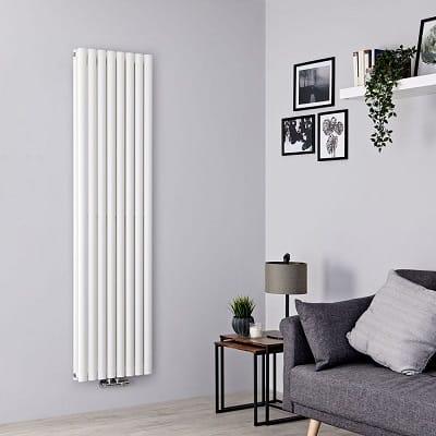 A white Milano Aruba flow radiator in a gray living room
