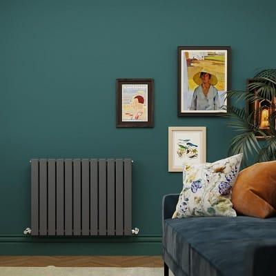 an anthracite Milano Alpha designer radiator in a green sitting room