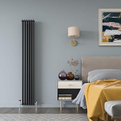 A Milano Windsor vertical column radiator in a bedroom