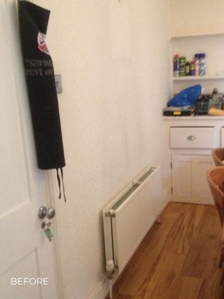 a horizontal radiator in a kitchen before a renovation