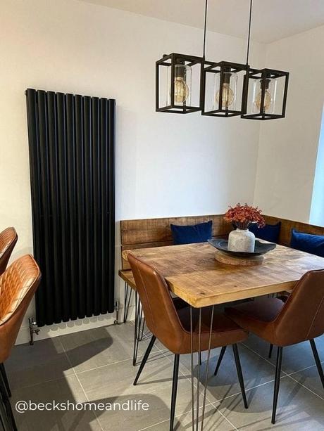 Modern vertical black radiator in a modern dining room area