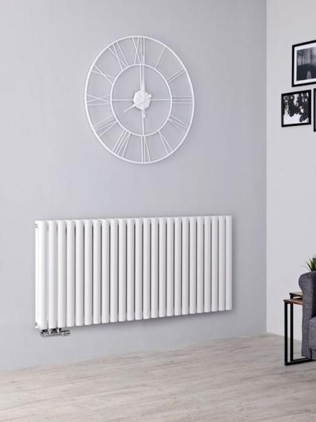 a white horizontal radiator on a grey wall