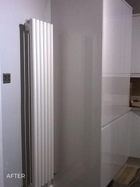 white vertical designer radiator in a kitchen