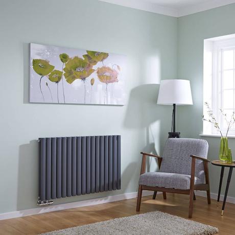 milano aruba anthracite horizontal radiator on a green living room wall