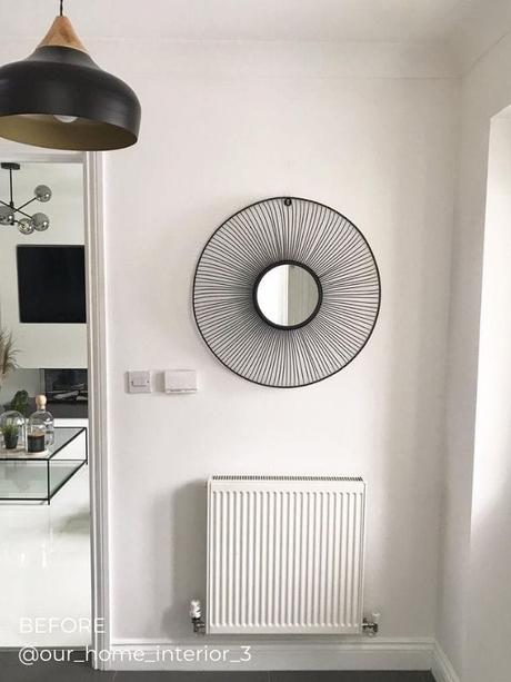 a standard white horizontal radiator in a hallway