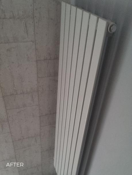 white vertical designer radiator in a hallway