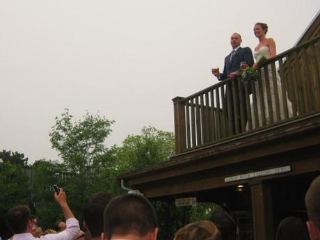 Bride and groom posing for pictures on balcony