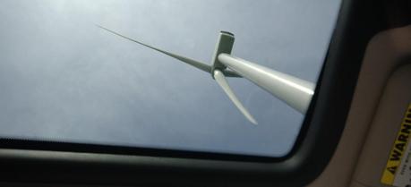 A wind turbine, viewed straight up through sunroof