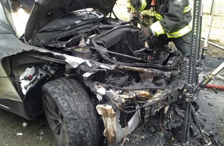 In this photo provided by the Tennessee Highway Patrol, emergency workers respond to a fire on a Tesla Model S electric car in Smyrna, Tenn.