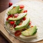 chicken and avocado caprese quesadillas on wood board