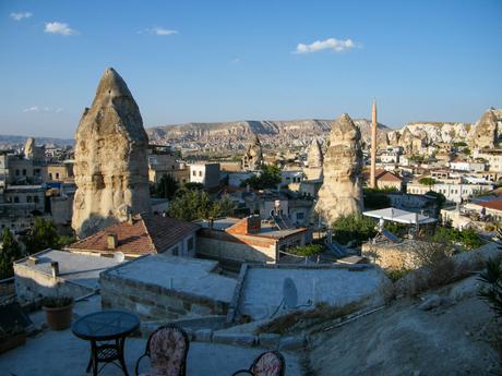 The cityscape of Göreme in Cappadocia, with its unique rock formations and cave dwellings, bathed in late afternoon light.