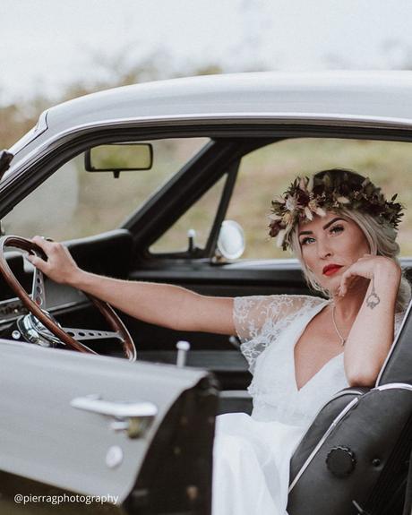 wedding transportation bride sits in the car with red lips and bridal wreath