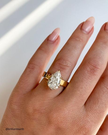The Heart of an Ethical Promise: More Than Just a Ring ethical engagement rings yellow gold three stone ring doamore yellow gold ring with pear cut diamond center stone brilliantearth