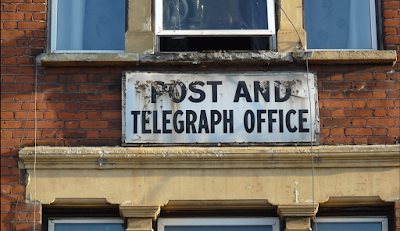 Who is removing the old metal Telephone and Telegraph signs?