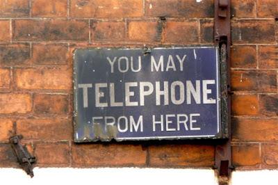 Who is removing the old metal Telephone and Telegraph signs?