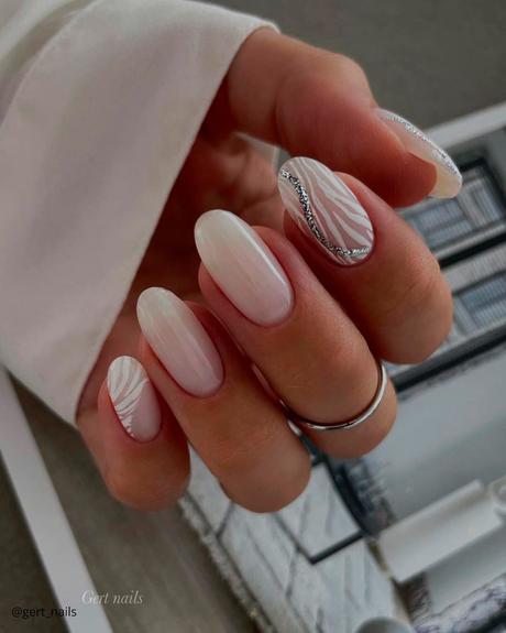 milky white nails with zebra print and silver gert nails