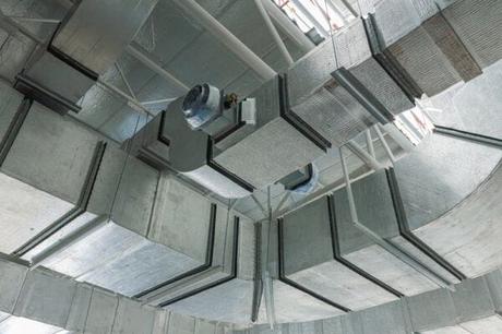 Silver HVAC ductwork system on ceiling of industrial building