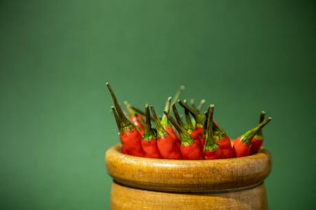 Small red chillies stacked in a wooden jar