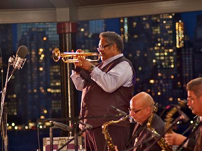 Claude 3.5 Sonata describes Jon Faddis fronting a big band on the waterfront at night