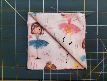 How I sew corner bookmarks Sewing a corner bookmark: lay one fabric square right side up, then place the folded triangle on top, aligning its raw edges with the top left of the square below.