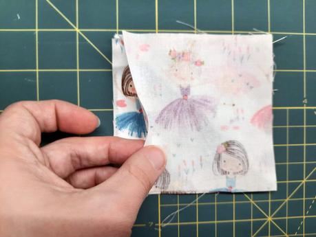 How I sew corner bookmarks Sewing a corner bookmark: add the third square on top, this time right side down, creating a sandwich with the triangle in the middle.