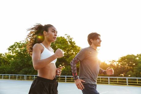 Exercise does burn calories – but not as much as you might think A young fit man and woman go for a run outdoors.