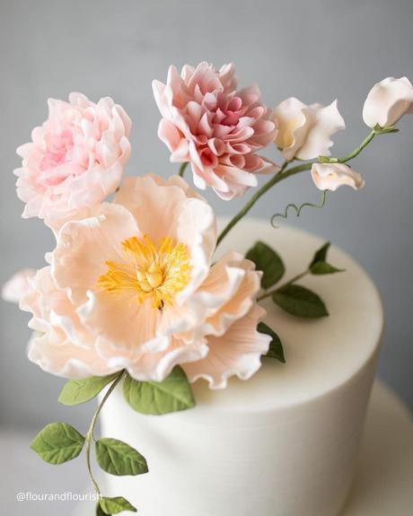 The Ultimate Guide to Using Fake Flowers for Your Wedding fake flowers small white wedding cake with sugar and fake pastel flowers