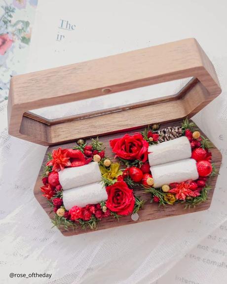 The Ultimate Guide to Using Fake Flowers for Your Wedding fake flowers wooden wedding ring box with small fake flowers decor inside
