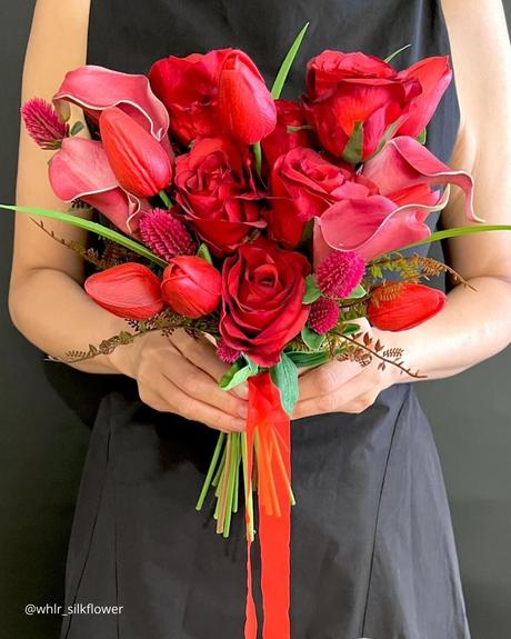 The Ultimate Guide to Using Fake Flowers for Your Wedding fake flowers bouquet of fake roses and tulips in red and pink shades