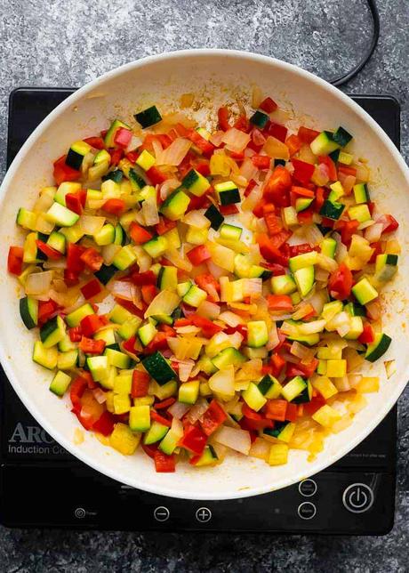 Vegetarian Enchiladas vegetables in a large skillet that have been cooked until tender
