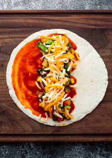 Vegetarian Enchiladas tortilla with enchilada sauce, filling and cheese