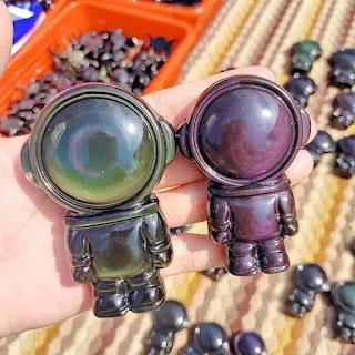 Celestial Harmony: The Art of Rainbow Obsidian Astronaut Carvings Celestial Harmony: The Art of Rainbow Obsidian Astronaut Carvings