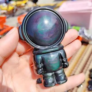 Celestial Harmony: The Art of Rainbow Obsidian Astronaut Carvings Celestial Harmony: The Art of Rainbow Obsidian Astronaut Carvings