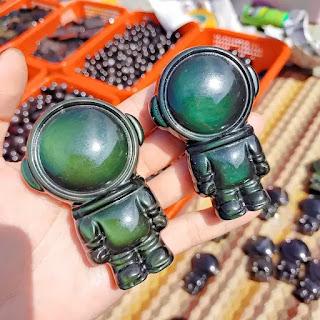 Celestial Harmony: The Art of Rainbow Obsidian Astronaut Carvings Celestial Harmony: The Art of Rainbow Obsidian Astronaut Carvings