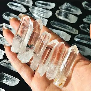Natural clear quartz rough point specimen on granite surface Natural clear quartz rough point specimen on granite surface