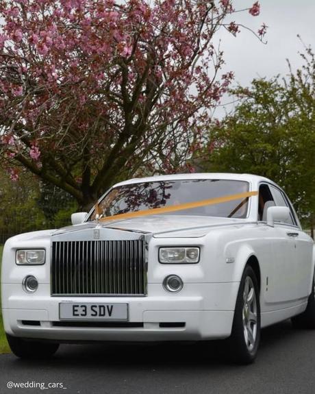 wedding car hire london white premium retro car with yellow ribbon circle tree with pink flowers wedding cars