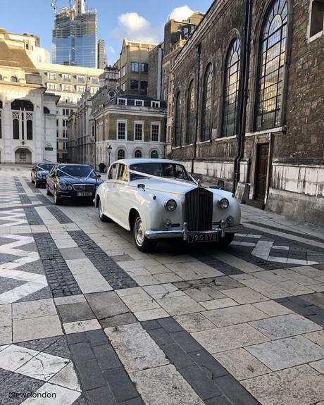 wedding car hire london column of cars in front white premium car on the background ancient building ewclondon