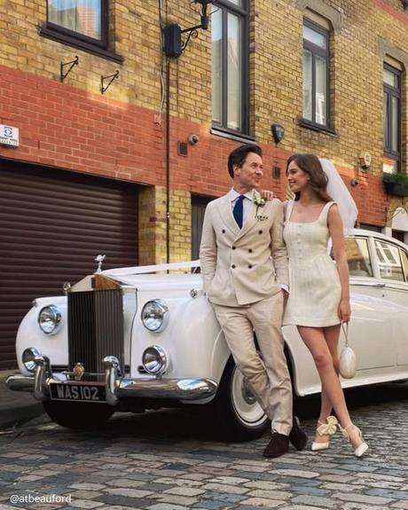 wedding car hire london brides hugging circle of white rutro premium car bride in a short dress atbeauford