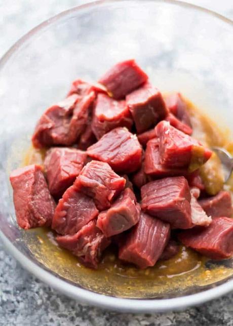 a closeup of steak tips with marinade