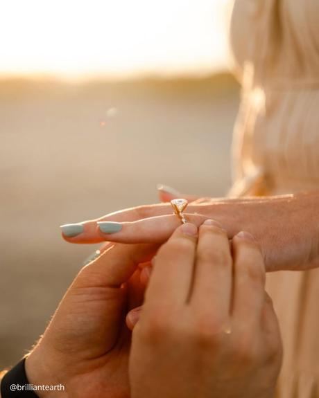 wedding ring finger close up photo of proposal engagement ring brilliantearth