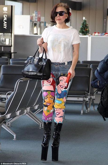 Gaga does Disney: Lady Gaga wore a pair of Disney-themed jeans as she jetted to London from Tokyo, Japan on Wednesday, but somewhat spoiled the look with her racy sky high patent leather platform boots 