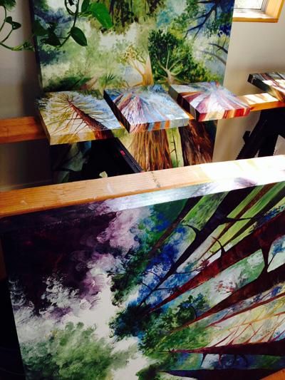 Redwood forest paintings on the drying rack in art studio of Cedar Lee