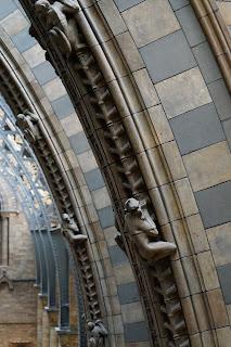 An abundance of animals Sections of two archways with monkeys climbing them; beyond are further arches, metal with plant motifs.
