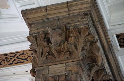 An abundance of animals A square pillar capital with luxurian foliage and an animal looking out between the leaves.